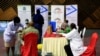 FILE - Kenyan tour guides and travel operators prepare to receive shots of the AstraZeneca coronavirus vaccine, under the COVAX program, in Nairobi, Kenya, April 27, 2021. 