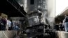 People look at a damaged train inside Ramsis train station in Cairo, Egypt, Wednesday, Feb. 27, 2019. The high-speed crash caused an explosion of the locomotive's fuel tank and triggered a huge blaze that engulfed that part of the station.