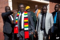 Zimbabwean President Emmerson Mnangagwa leaves the polling station after casting his vote for the presidential elections at the Sherwood Primary School in Kwekwe, Zimbabwe, July 30, 2018.
