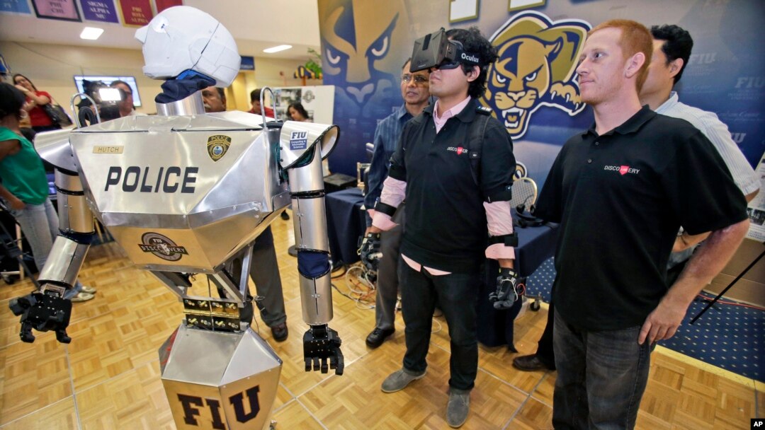 FILE - Students control a "Robocop" during a demonstration at Florida International University in Miami.