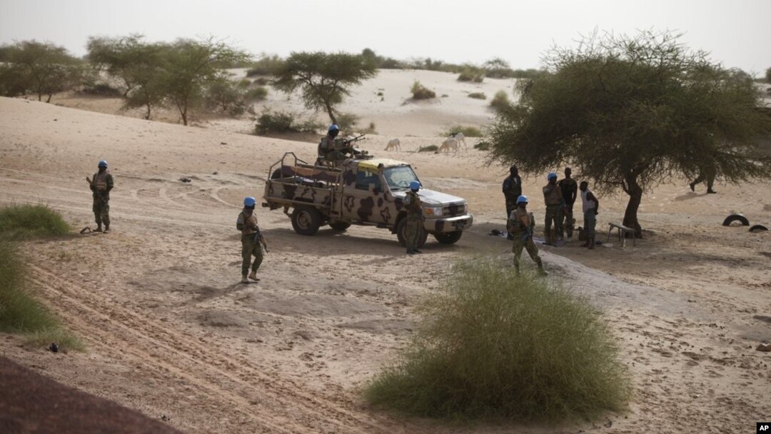 FILE - United Nations peacekeepers patrol on the outskirts of Timbuktu, Mali, July 23, 2013.