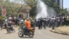 FILE - Protesters break a water line in the center of Kisumu, Kenya, during anti-electoral commission protests, Oct. 6, 2017, ahead of the upcoming rerun presidential election. (J. Craig/VOA)
