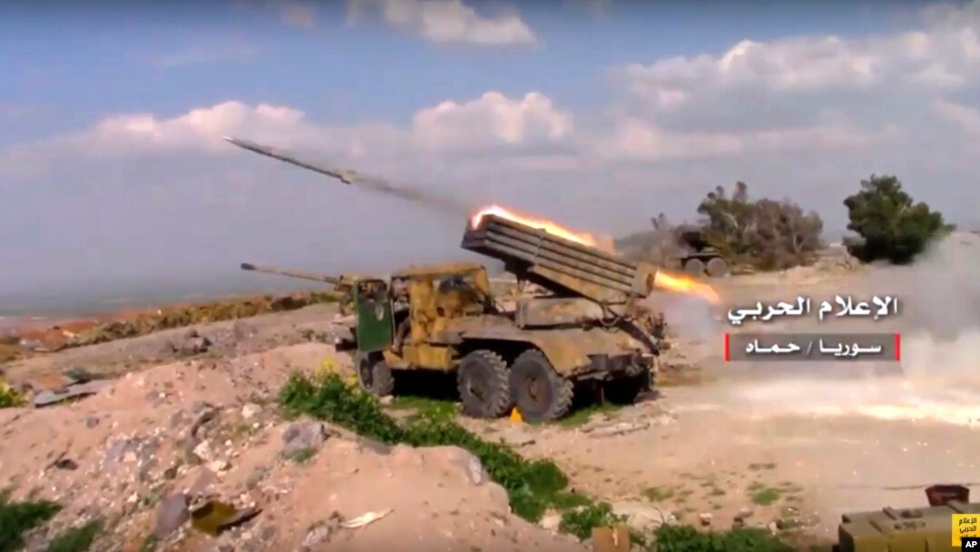 FILE - In this Friday, March 31, 2017 frame grab from video provided by the government-controlled Syrian Central Military Media, Syrian army rocket launcher fires at insurgent groups position, in Hama, north Syria.