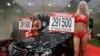 FILE - Models advertise "Geely Otaka," a car designed in China, during an auto show in Moscow, Russia.