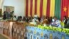 Supporters of Cameroon President Paul Biya, with a poster depicting Biya in the background, are seen gathered in Monatele, Nov. 6, 2021. (Moki Edwin Kindzeka/VOA)