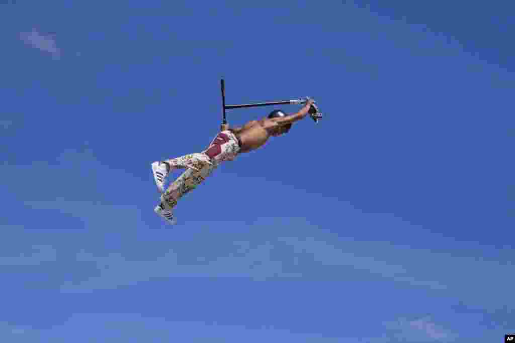 A participant performs tricks on his scooter during the Urban Sports event in Madrid, Spain.