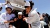 Nurses support an injured woman who is taken to a hospital in Minxian county, Dingxi, Gansu province, July 22, 2013. 