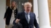 FILE - PM hopeful Boris Johnson leaves his home in London, Britain, June 13, 2019.