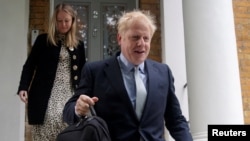 FILE - PM hopeful Boris Johnson leaves his home in London, Britain, June 13, 2019.