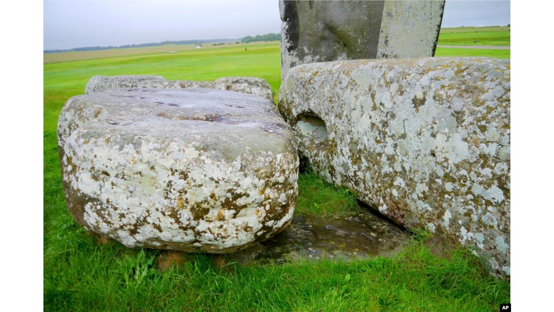 In this photo provided by researchers in August 2024, Stonehenge's Altar Stone lies underneath two Sarsen stones in Wiltshire, England. (Nick Pearce/Aberystwyth University via AP)