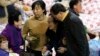The family member of a missing passenger who was on South Korean ferry Sewol, which sank in the sea off Jindo, is helped as she cries while waiting for news from the rescue team, at a gym in Jindo, Apr. 18, 2014. 
