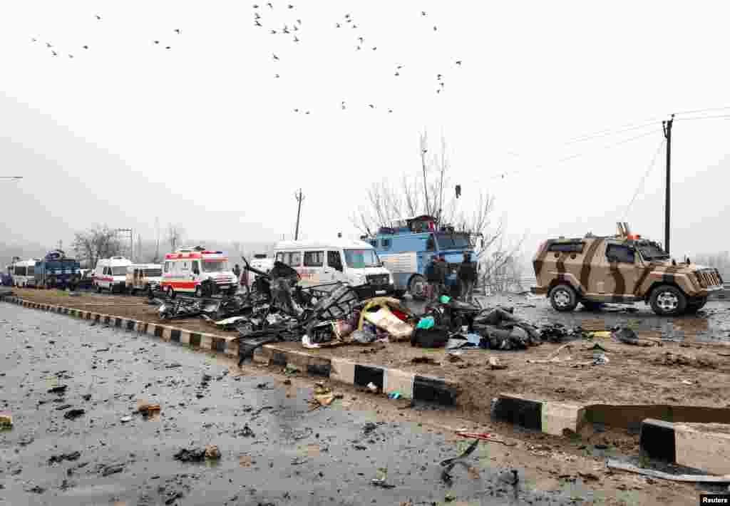 Indian soldiers examine the debris after an explosion in Lethpora in south Kashmir&#39;s Pulwama district.