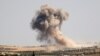 Smoke billows during pro-regime bombardments in the area of Maar Hitat in Syria's northern Idlib province, Aug. 20, 2019.