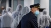 FILE - A pilot and crew members of South African Airways go through the security check in Frankfurt, Germany, April 18, 2020.