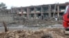 Afghan security personnel inspect the site of an attack on an army base in Gardez, capital of Paktia province, May 14, 2020.