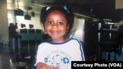 5-year-old Maya Hughes poses the day she left Sierra Leone. Maya’s mother, Zainab Sesay, brought the pair to the West African country in 2003 to reconnect with their roots and introduce Maya to her great grandmother.