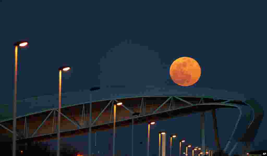 A supermoon rises over Tagus river in downtown Lisbon, Portugal, Feb. 19, 2019.