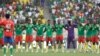 Cameroon players observe a minute of silent for the victims of the stampede, before the start of the African Cup of Nations 2022 quarter-final soccer match between Gambia and Cameroon at the Japoma Stadium in Douala, Cameroon, Jan. 29, 2022.