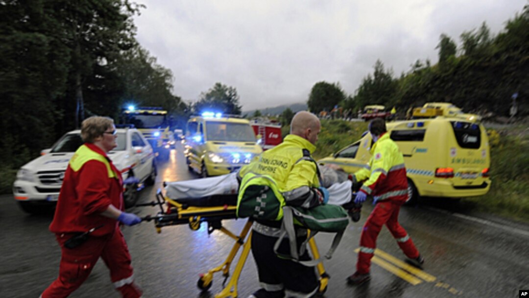 Rescue personnel push an injured victim away from the camp site in Utoeya, Norway, July 23, 2011