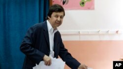FILE - Said Bouteflika, brother of then-Algerian President Abdelaziz Bouteflika, prepares to vote in Algiers, May 4, 2017. Said Bouteflika was detained May 4, 2019, for questioning along with two generals who previously ran state security agencies, a security official said. 