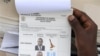 Uganda presidential elections ballot paper is held by election worker at a polling station in Rukungiri about 319 kilometers (199 miles) west of Uganda capital Kampala Friday Feb. 18, 2011. Uganda's long-serving president says he will not become the late