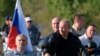 Russian President Vladimir Putin drives a motorbike during the Babylon's Shadow bike show camp near in Sevastopol, Crimea, Aug. 10, 2019. 