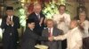 Government peace negotiator Marvic Leonen (R) and Moro Islamic Liberation Front chief negotiator Mohagher Iqbal (L) shake hands following a formal signing ceremony in Manila, Philippines, October 15, 2012.