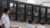 FILE - Islamist defendants stand behind bars in the case known as the "Kerdasa massacre'', that referred 188 people to court over an attack that killed 14 policemen in 2013, in Cairo June 23, 2014. 