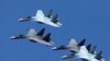 FILE - Sukhoi Su-35 jet fighters of the "Sokoly Rossii" (Falcons of Russia) aerobatic team fly in formation during a rehearsal for the airshow in Krasnoyarsk, Russia, Aug. 1, 2019.