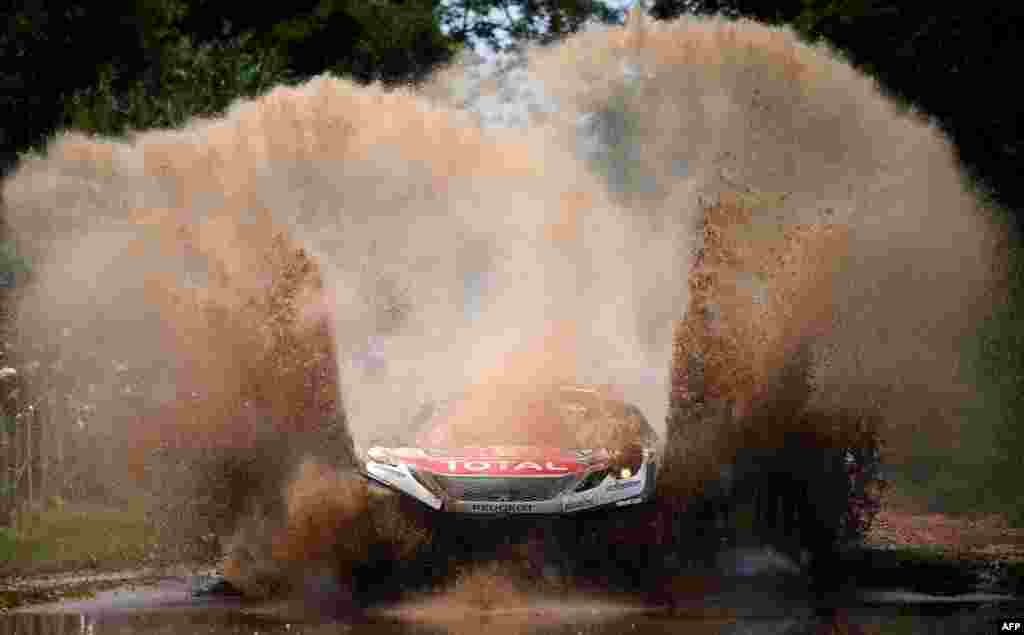 Peugeot's pilot Sebastien Loeb and co-pilot Daniel Elena, both from France, compete during the 2017 Dakar Rally Stage 1 between Asuncion and Resistencia, in Argentina, Jan. 2, 2017.