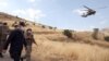 FILE - Turkish Defense Minister Hulusi Akar, left, visits Turkish troops at the border with Iraq, in Hakkari province, June 19, 2020.