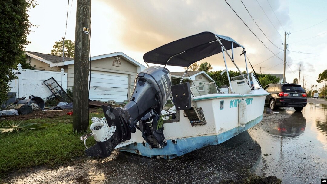 A boat rests on a street after being relocated during flooding caused by Hurricane Helene, Sept. 27, 2024, in Hudson, Florida.