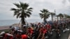 The pack rides along the beach of the Promenade des Anglais during the first stage of the Tour de France, with start and finish in Nice, southern France, Aug. 29, 2020.