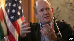 FILE - U.S. Senator Chris Coons speaks during a press conference with Senator Lindsey Graham, in Amman, Jordan, Feb. 20, 2018. 