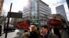 People walk past the building that houses the offices of Cambridge Analytica in central London, March 20, 2018. 