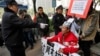A policeman points to a supporter of Southern Weekly newspaper in a wheelchair before taken him away during a protest near the headquarters of the newspaper in Guangzhou, Guangdong province, China, Jan. 10, 2013. 