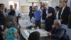 U.S. Secretary of State John Kerry, center right, greets a group of Syrian refugees during a joint meeting with Jordanian Foreign Minister Nasser Judeh, sitting at right, at the Zaatari refugee camp near Mafraq, Jordan, July 18, 2013.