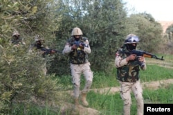 FILE - Egyptian Army officers are seen in the troubled northern part of the Sinai Peninsula during a launch of a major assault against militants, in Al Arish, Egypt, in this undated handout picture made available by the Ministry of Defense, March 4, 2018.