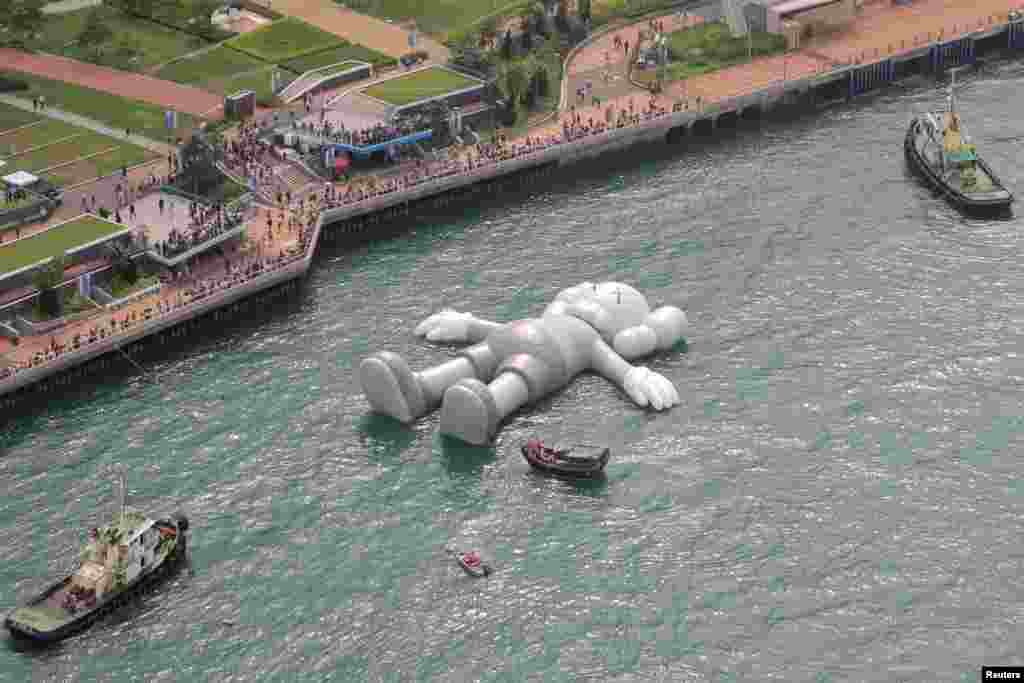A giant 'Companion' inflatable sculpture by US artist Brian Donnelly, known professionally as Kaws, is displayed at the Victoria Harbor in Hong Kong, China.