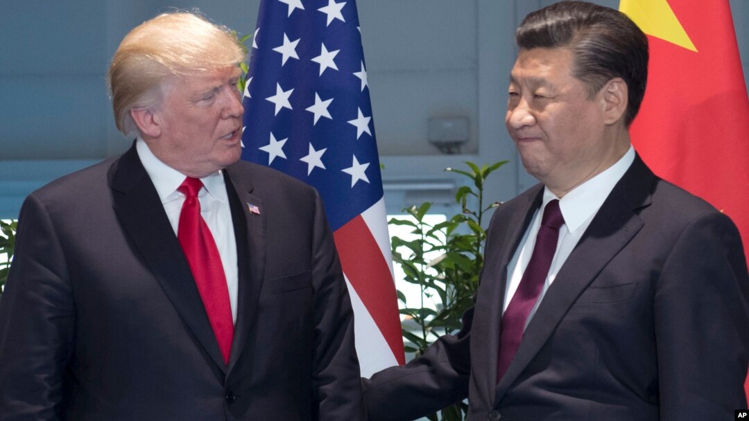 FILE - , U.S. President Donald Trump, left, and Chinese President Xi Jinping arrive for a meeting on the sidelines of the G-20 Summit in Hamburg, Germany.