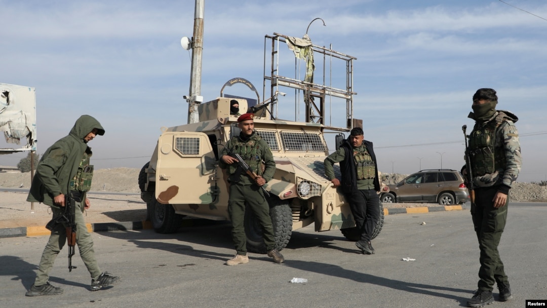 Members of Kurdish-led Syrian Democratic Forces stand along a street after rebels seized the capital and ousted Syria's Bashar al-Assad, in Hasakah, Syria, Dec. 11, 2024.