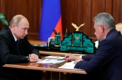 Russian President Vladimir Putin, left, listens to Russian Defense Minister Sergey Shoigu during their meeting in the Kremlin in Moscow, Russia, July 4, 2019.