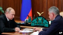 Russian President Vladimir Putin, left, listens to Russian Defense Minister Sergei Shoigu during their meeting in the Kremlin in Moscow, Russia, July 4, 2019. 