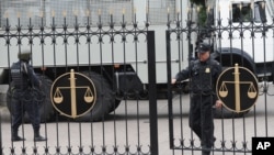 FILE - Police officers guard a court building in Rostov-on-Don, Russia, Sept. 15, 2015. 