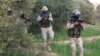 FILE - Egyptian Army officers are seen in the troubled northern part of the Sinai Peninsula during a launch of a major assault against militants, in Al Arish, Egypt, in this undated handout picture made available by the Ministry of Defense, March 4, 2018.