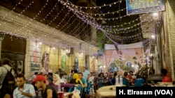 The introduction in recent years of lower-consumption LED bulbs mean many Cairo residents, like patrons and this street café, can continue to enjoy bright lights on a summer’s eve. 