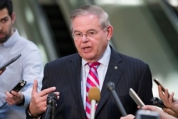 FILE - Democratic Sen. Bob Menendez speaks with reporters on Capitol Hill in Washington, March 5, 2019.