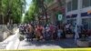 People are prevented to enter a security area after an explosion in Tunis, Thursday June 27, 2019. 