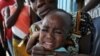 A health worker administers a yellow fever vaccine to a baby on a roadside in Koumassi, a poor area of Abidjan, after a case of yellow fever was discovered (File)