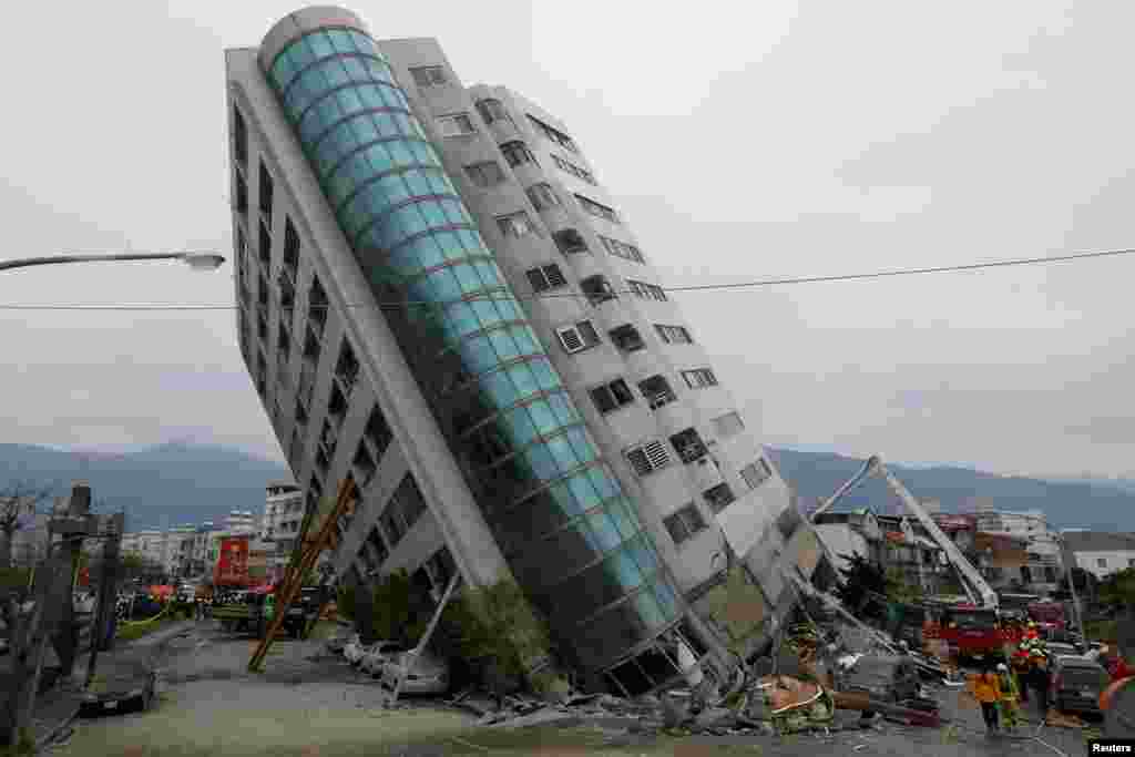 Rescue workers are seen by a damaged building after an earthquake hit Hualien, Taiwan, Feb. 7, 2018.
